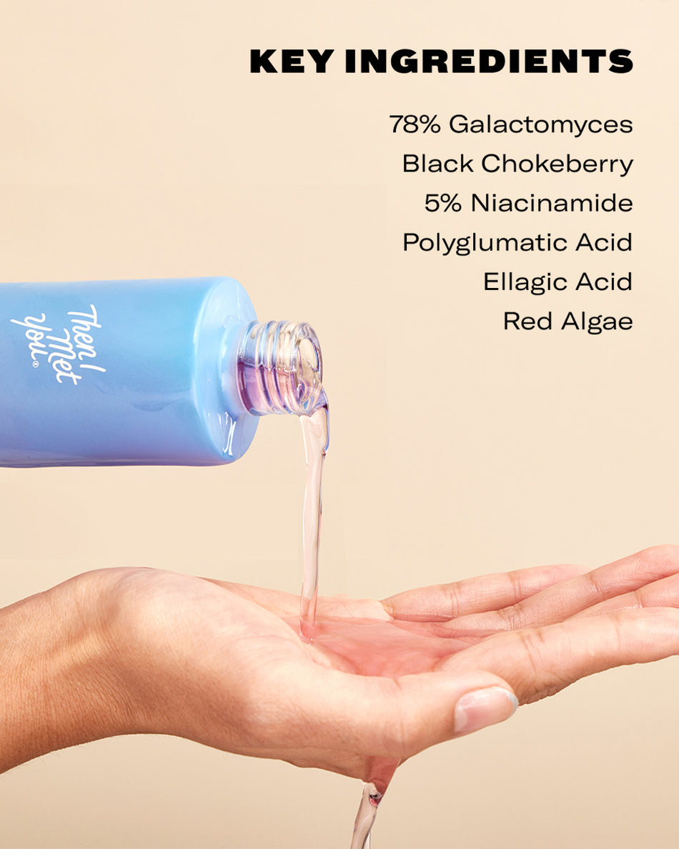 Blue bottle pouring clear serum onto hand with beige background and key ingredient list on top.