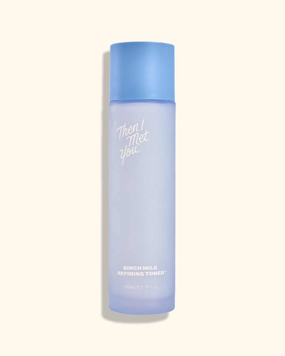 Tall frosted blue bottle with matching cap and white Birch Milk Refining Toner text on front.