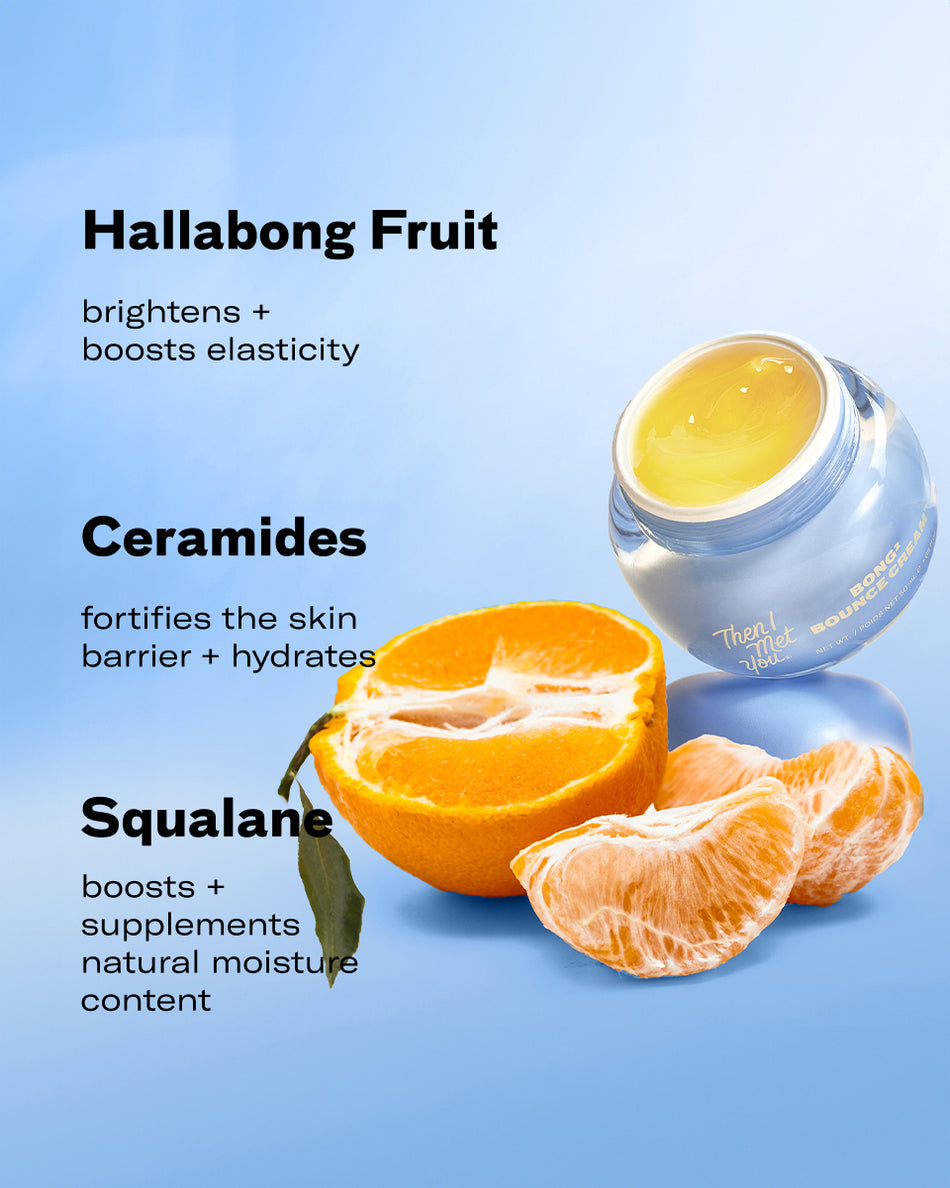 Small jar of Bong² Bounce™ Cream with yellow cream inside, next to a halved and peeled bright orange citrus fruit on a light .