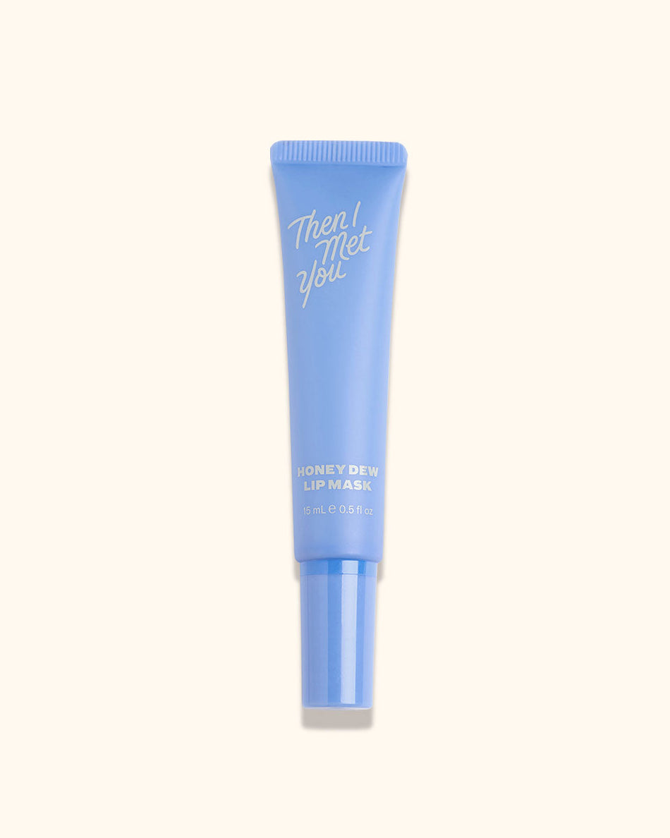 Light blue glossy tube with white handwritten-style text and a clear cap.