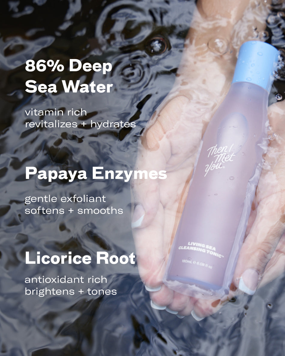 Lavender-colored Living Sea Cleansing Tonic bottle with light blue cap held in water with ripples.
