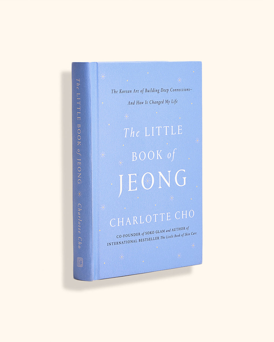 Light blue hardcover book titled The Little Book of Jeong by Charlotte Cho with small white star accents on cover.