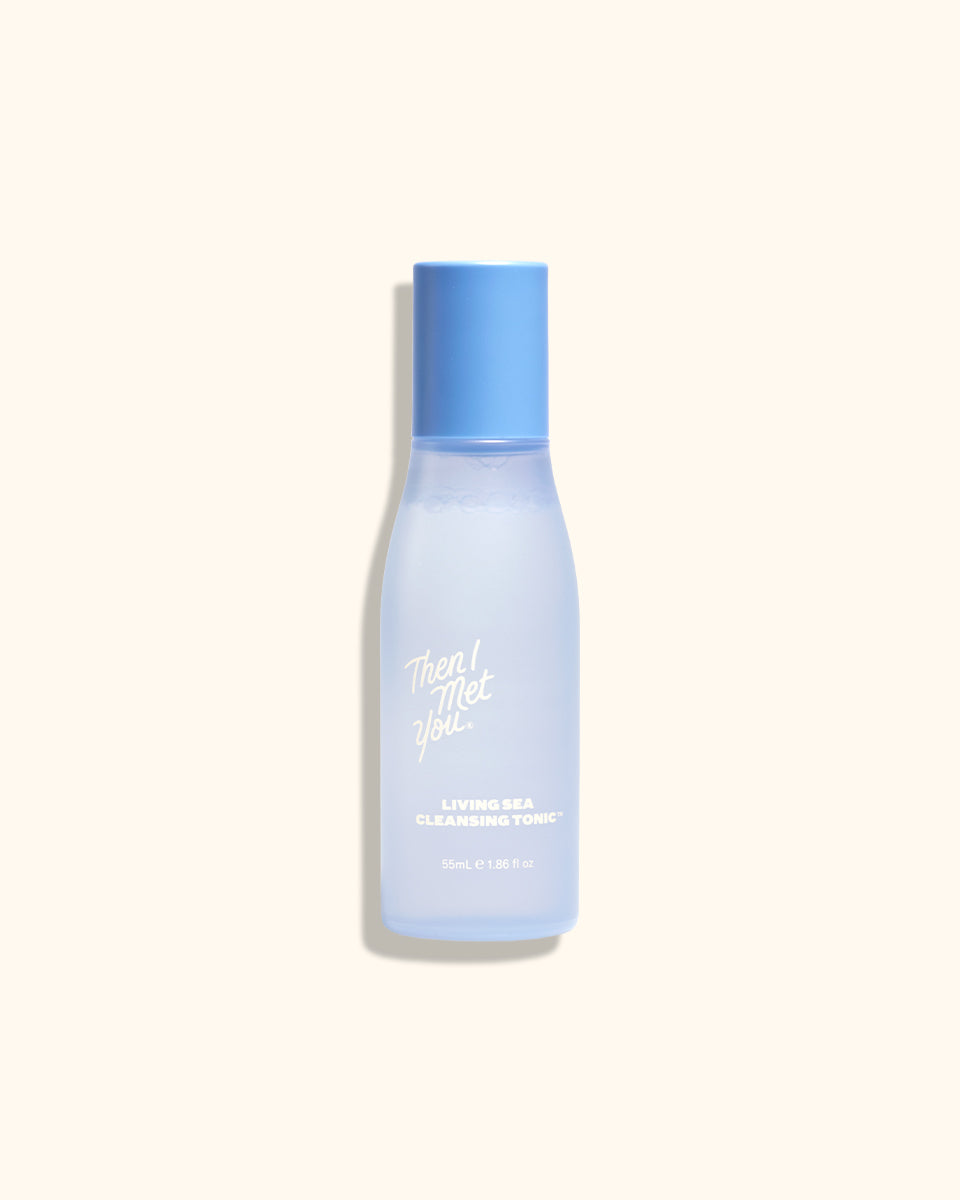 Travel-size translucent blue cleansing tonic bottle with blue cap and white text.
